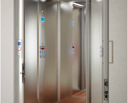 silver elevator in a room with a door open